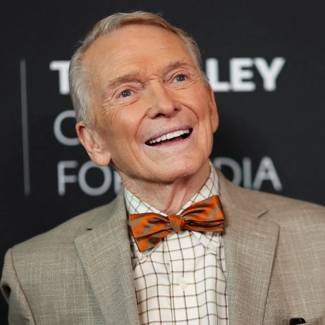 Bob Mackie’s death, at a hospital, was caused by pneumonia, his longtime design director said.
