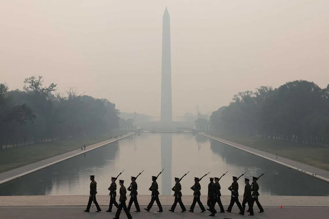 Members of the U.S. Marine Corps rehearse in hazy smoke for the Sunset Parade at the Lincoln Memorial on June 8, in Washington, DC. Air quality alert has been elevated to a Code Purple due to smoke from wildfires burning in Canada, indicating very unhealthy air conditions for the public. 