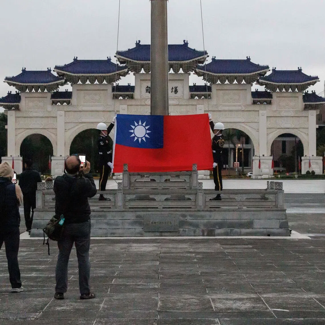 Taiwan's national flag is raised during an early morning flag-raising ceremony following China's People’s Liberation Army said it would conduct live-fire drills in five designated maritime and airspace areas around Taiwan, in Taipei on December 30, 2025. (Photo by CHENG Yu-chen / AFP)