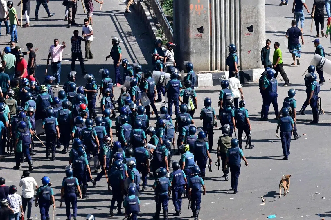 Bangladesh police try to disperse protesters during a clash with police in Dhaka on Aug 4.