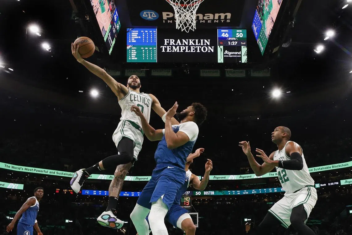 Boston Celtics forward Jayson Tatum drives to the basket over Minnesota Timberwolves centre Karl-Anthony Towns during the first half at TD Garden.