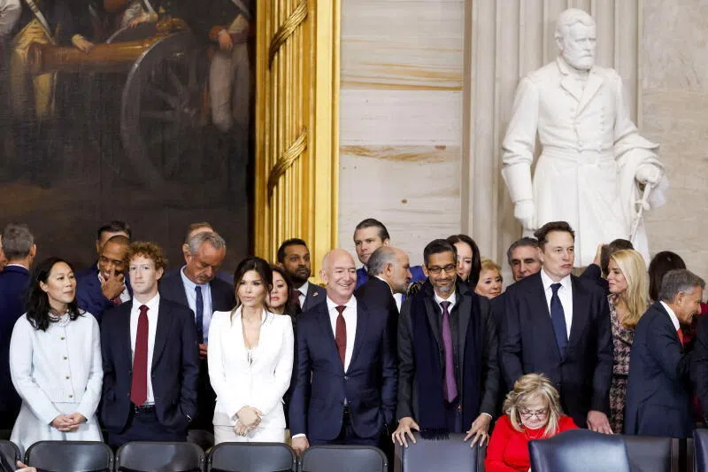 A gallery of "CEO courtiers" at US President Donald Trump's inauguration in January. (From left, front row) Ms Priscilla Chan, her husband Meta CEO Mark Zuckerberg, Ms Lauren Sanchez, her husband Amazon founder Jeff Bezos, Google boss Sundar Pichai and tech tycoon Elon Musk.