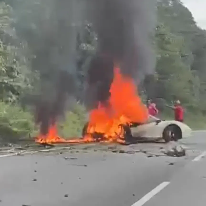 In a video of the accident seen by ST, thick plumes of black smoke are seen billowing from flames engulfing a badly damaged white Ferrari on a road shoulder.