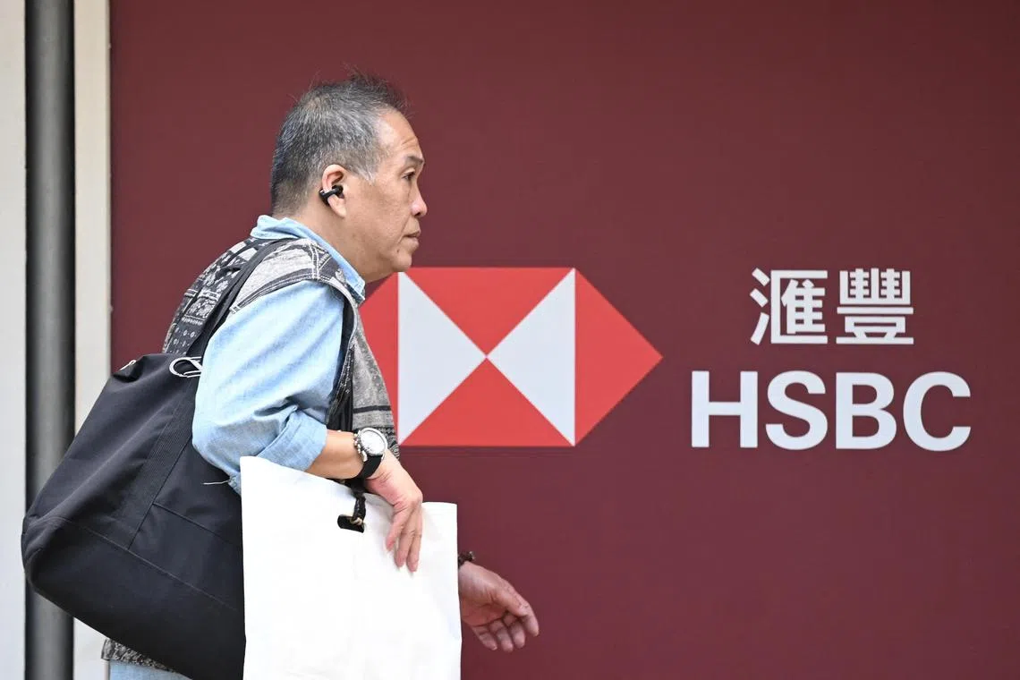 A man walks outside the headquarters of the Hong Kong and Shanghai Banking Corporation Limited (HSBC) in Hong Kong on February 21, 2024. HSBC said it achieved "record profit performance" in 2023 as pre-tax profits soared by nearly 80 percent, with the banking giant also announcing further share buybacks. (Photo by Peter PARKS / AFP)