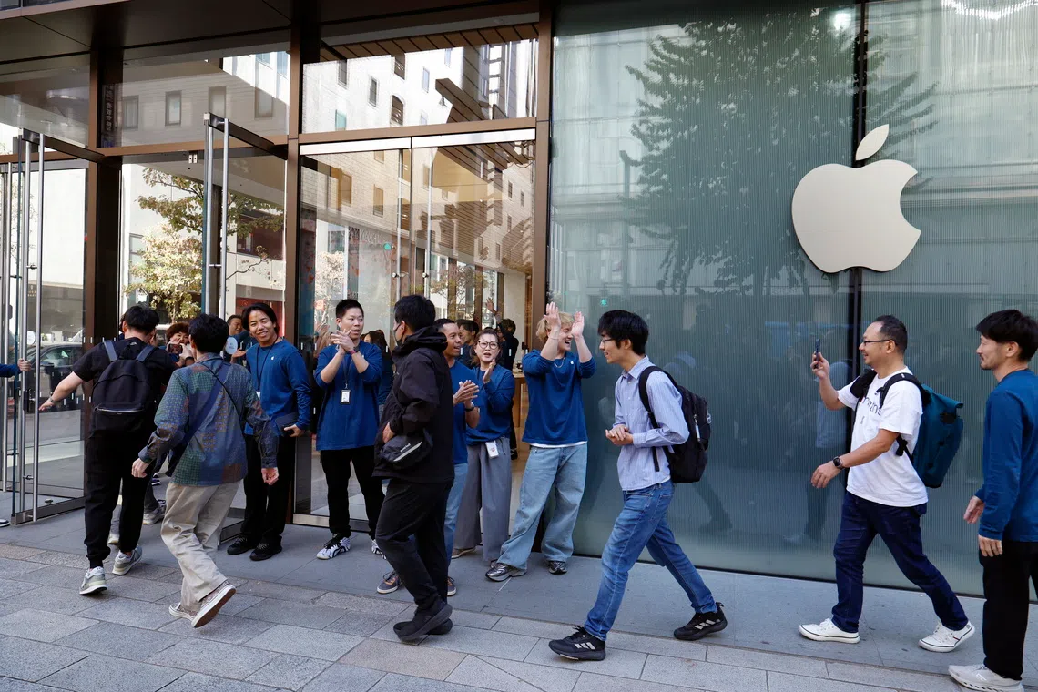 The first customers entering the Apple Ginza store in Tokyo as the iPhone Duo goes on sale on Oct 23.