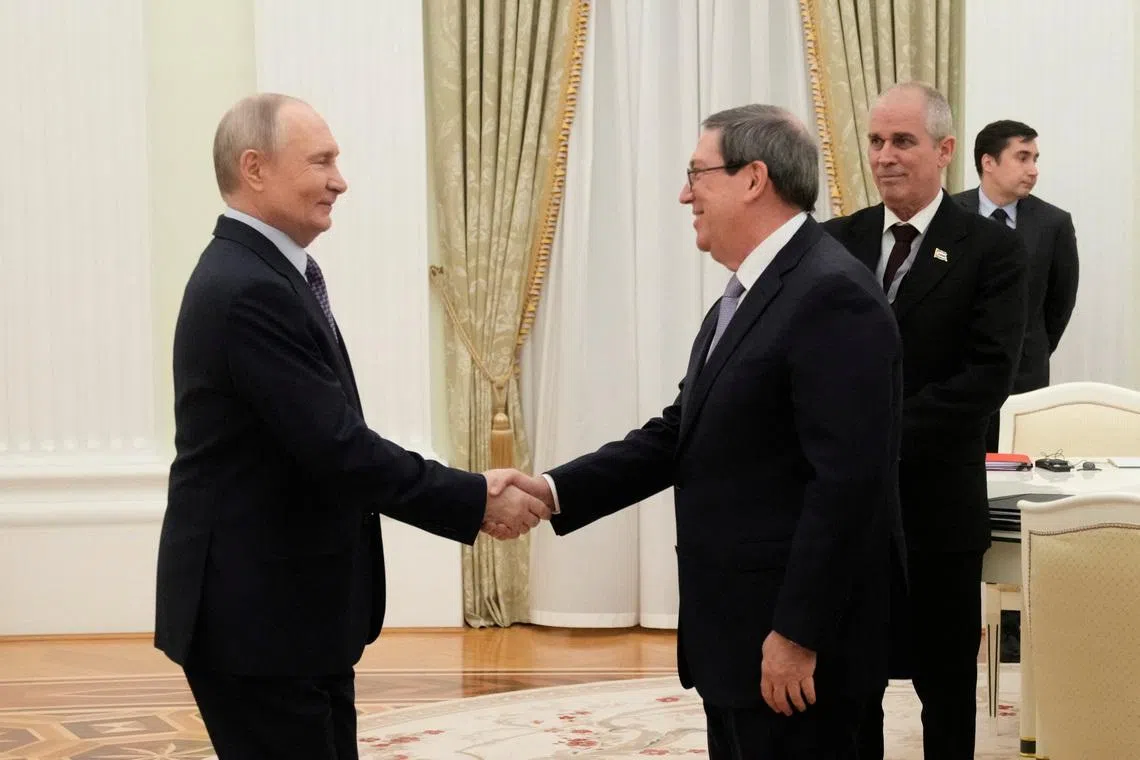 Russian President Vladimir Putin shakes hands with Cuban Foreign Minister Bruno Rodriguez Parrilla during their meeting at the Senate Palace of the Kremlin in Moscow, Russia, February 18, 2026. Pavel Bednyakov/Pool via REUTERS