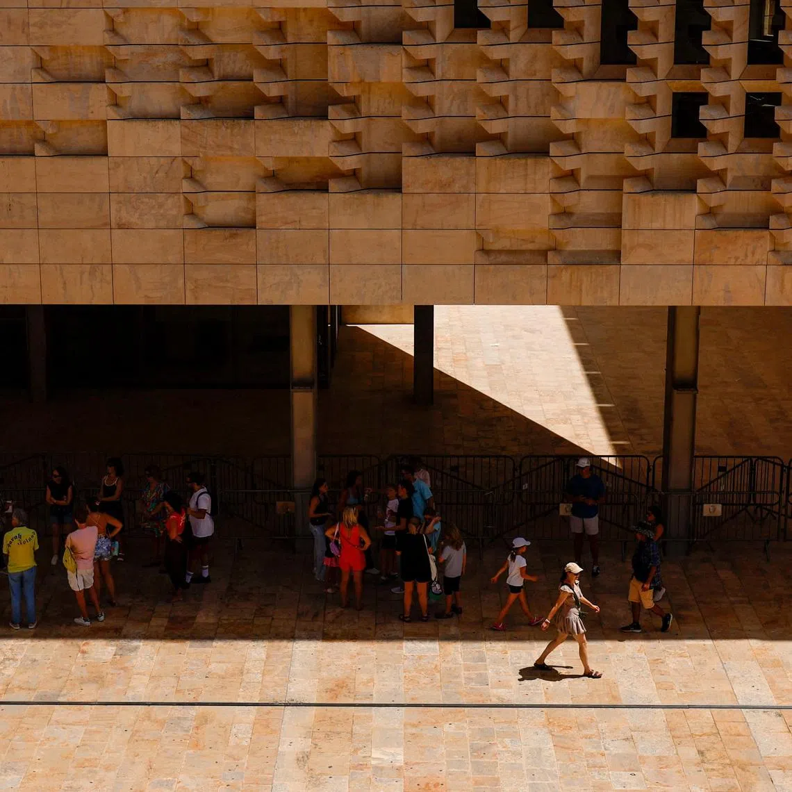 People shelter from the sun outside Parliament House during a heatwave, in Valletta, Malta July 18, 2026. REUTERS/Darrin Zammit Lupi