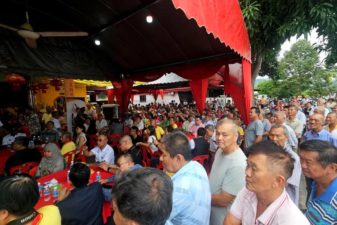 Villagers attending an event in Jementah, Johor, on June 24, where Transport Minister Anthony Loke marked the completion of a solar panel installation with a symbolic cheque presentation.