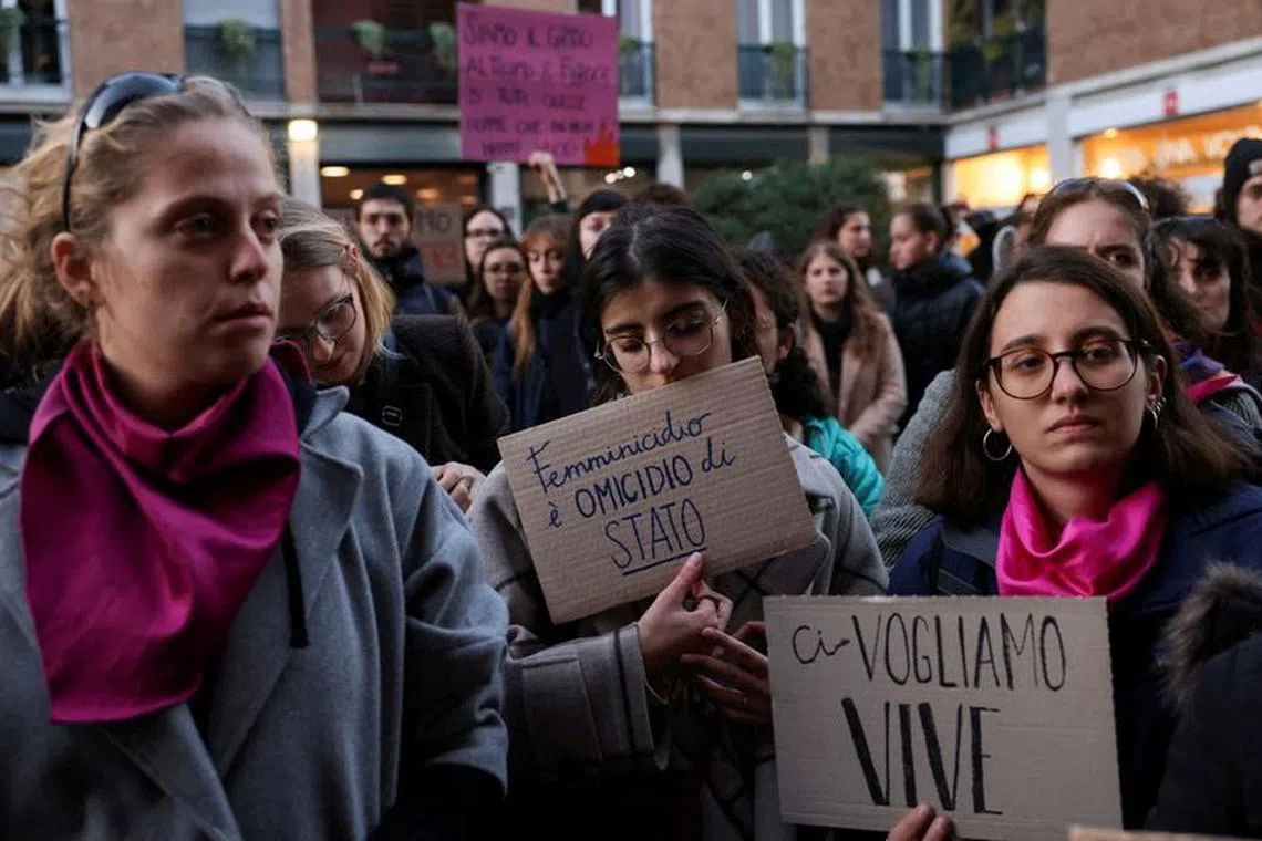 Students hold banners reading "Femincide is a state murder" and "We want us alive" as they perform a flash mob to protest against feminicide and violence against women, following 22-years-old Giulia Cecchettin's murder.
