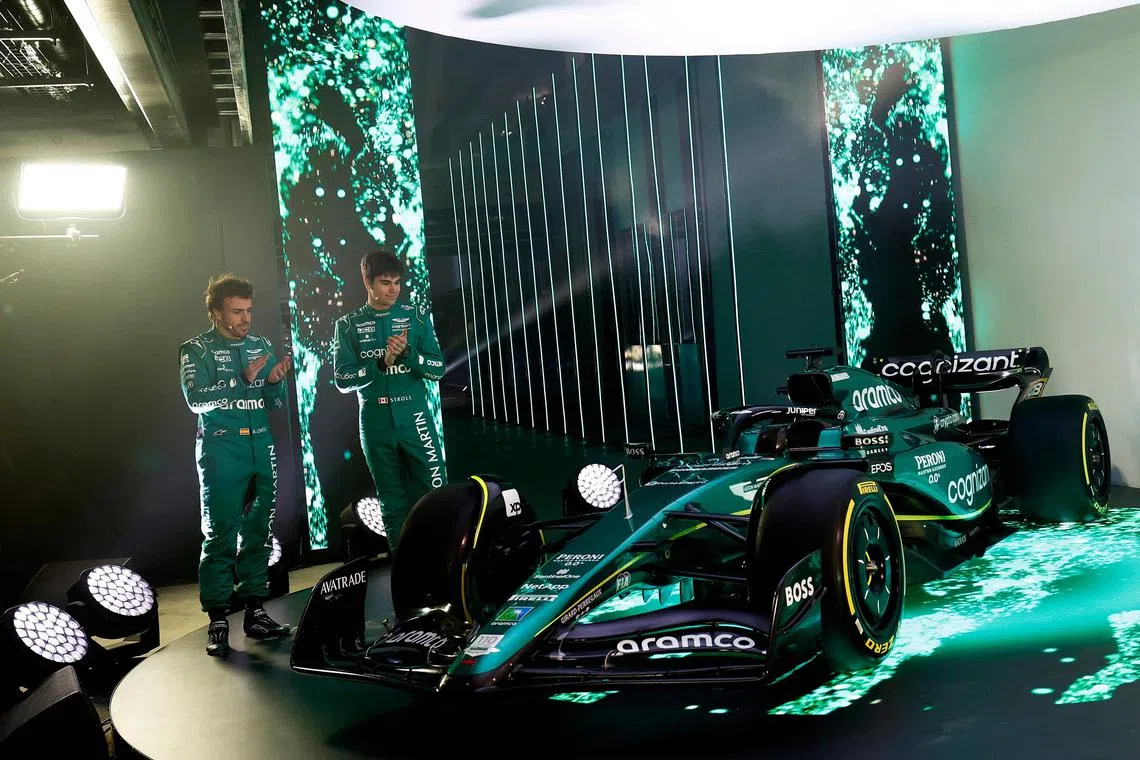 Formula 1 drivers Fernando Alonso (left) and Lance Stroll standing next to the Aston Martin AMR23 car for the 2023 season, during its unveiling at their headquarters in Silverstone on Feb 13.