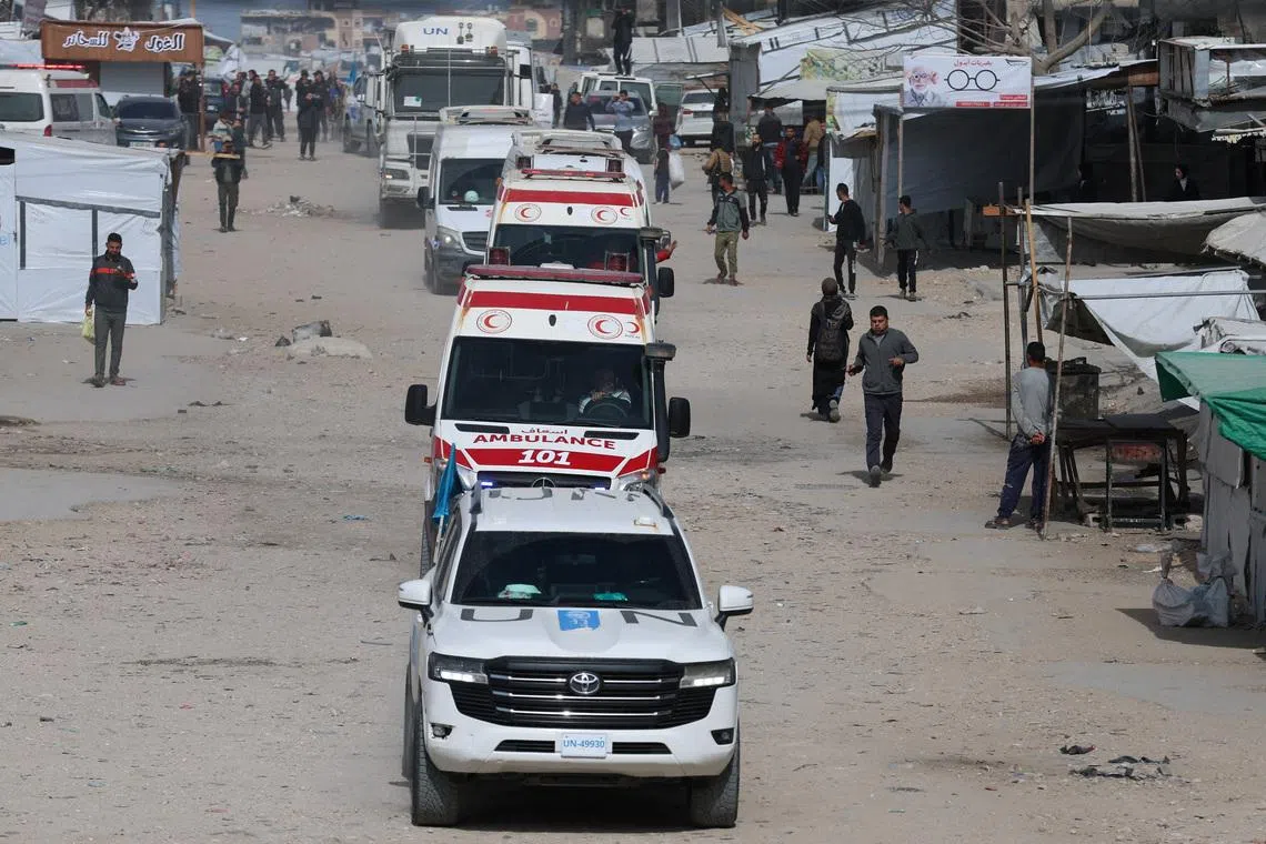 A UN vehicle leads ambulances carrying war-wounded people and patients who leave Gaza, for treatment abroad, through the Rafah border crossing between Gaza and Egypt after it was opened by Israel on Thursday for a limited number of people, in Khan Younis in the southern Gaza Strip, March 19, 2026. REUTERS/Ramadan Abed