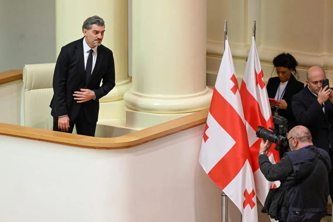 Mr Mikheil Kavelashvili posing for photographs after being elected by lawmakers as Georgia's new president on Dec 14. He was the only nominee. 
