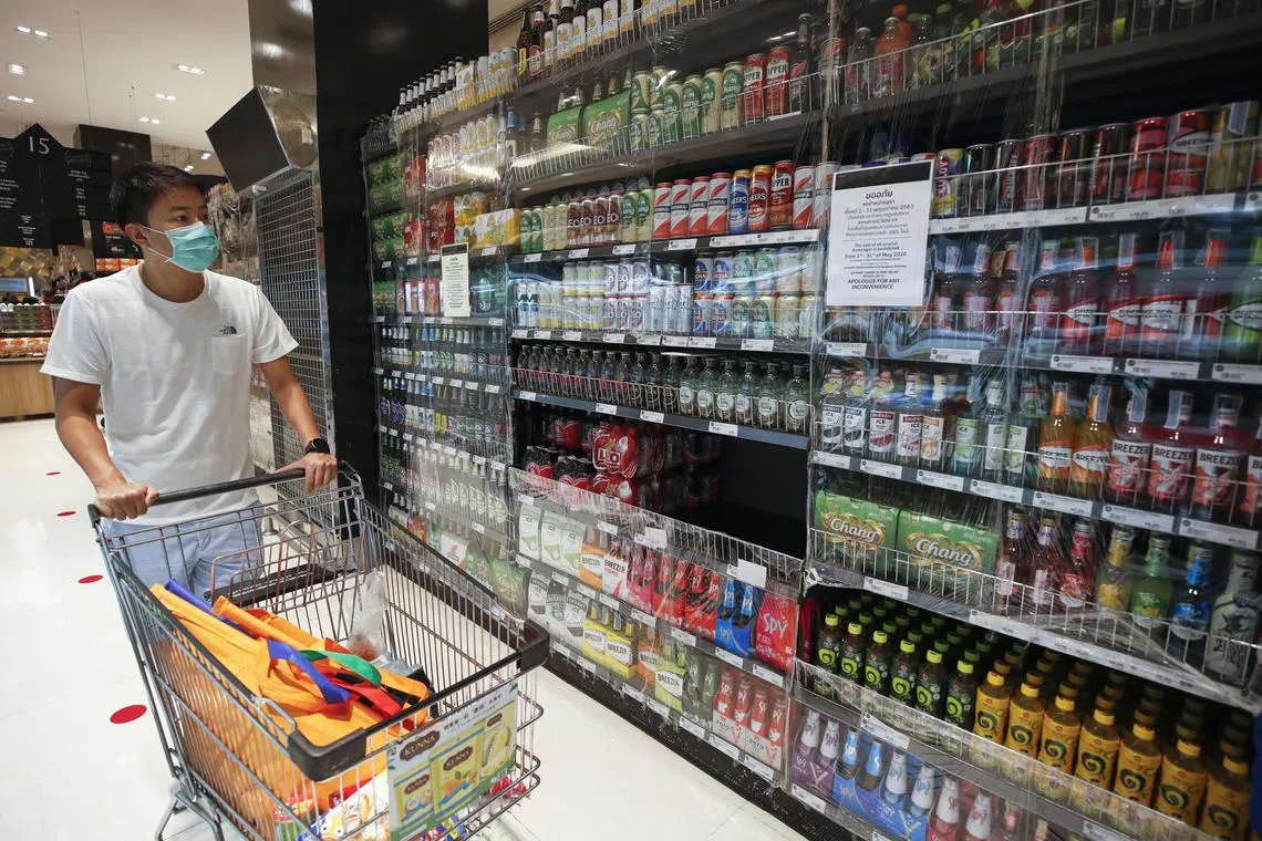 hyletter18 - epa08397100 A shopper looks on plastic sealed shelves of sales banning alcoholic beverages as part of the government's measures to combat the COVID-19 coronavirus pandemic, at a grocery store in Bangkok, Thailand, 02 May 2020.  The Thai government announced to allow the sales of alcohol and liquor for drinking at home only from 03 May 2020, as part of the easing some stringent measures imposed to curb the ongoing COVID-19 coronavirus pandemic after the number of infections in Thailand has been dropped while the state of emergency decree and curfew will remain for another month until the end of May.  EPA-EFE/RUNGROJ YONGRIT