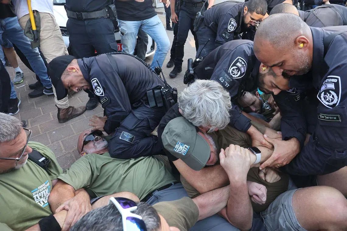 Israeli police disperse protesters as they block the entrance to the residence of Justice Minister Yariv Levin, in the central city of Modiin on Sept 11, as they protest against the government's controversial judicial reform bill. 