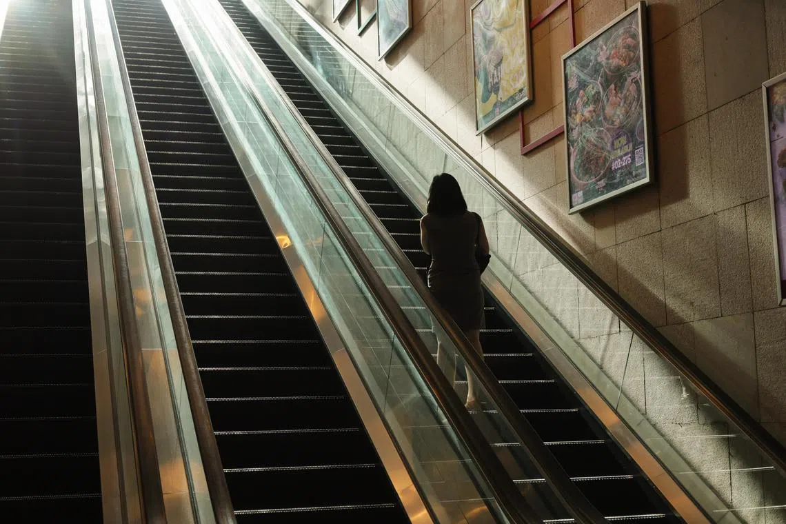 ST20231106_202326521432: Gin Tay/ pixgeneric/ Generic photo of people travelling on an escalator on Nov 6, 2023. Can use stories on employment, depression, loneliness, office workers,