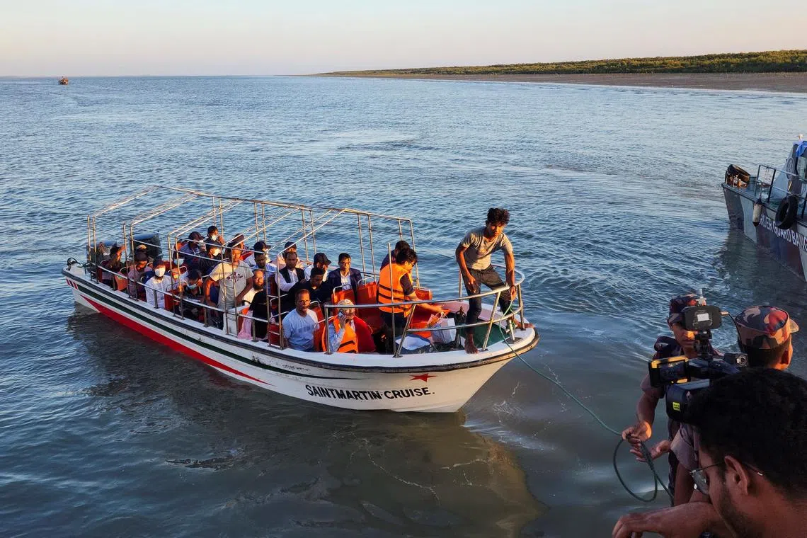 Some Rohingya Muslim refugees and Bangladeshi officials on a boat return after visiting Myanmar's Rakhine State as part of an effort to encourage their voluntary repatriation.