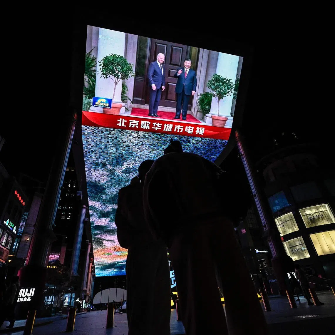 An outdoor screen in Beijing shows a news programme about Chinese President Xi Jinping meeting US President Joe Biden during the Apec summit.