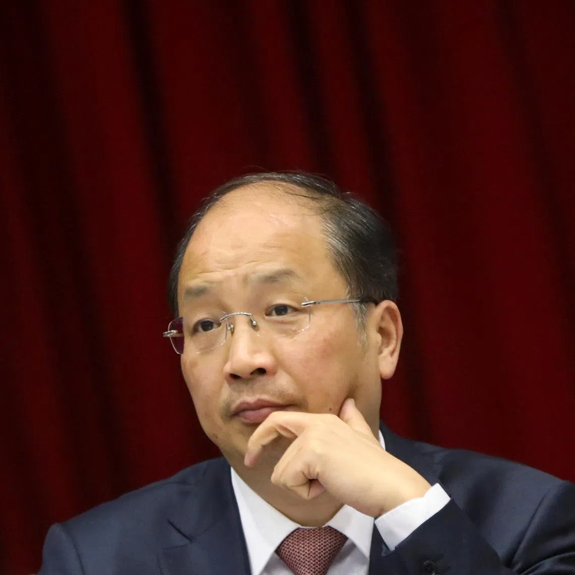 FILE PHOTO: Yi Huiman, chairman of China Securities Regulatory Commission (CSRC), attends a meeting of Fujian delegation on the sidelines of the National People's Congress (NPC), at the Great Hall of the People in Beijing, China March 5, 2019. Picture taken March 5, 2019. REUTERS/Stringer/File photo