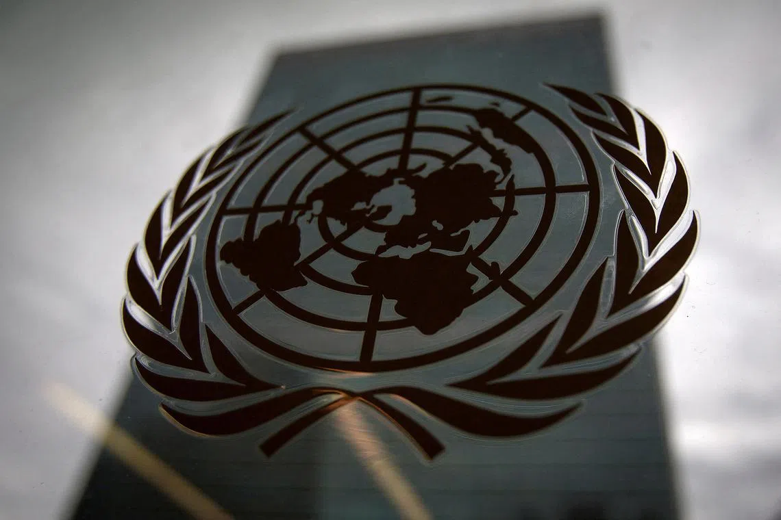 FILE PHOTO: The United Nations headquarters building is pictured though a window with the UN logo in the foreground in the Manhattan borough of New York August 15, 2014. REUTERS/Carlo Allegri/File Photo