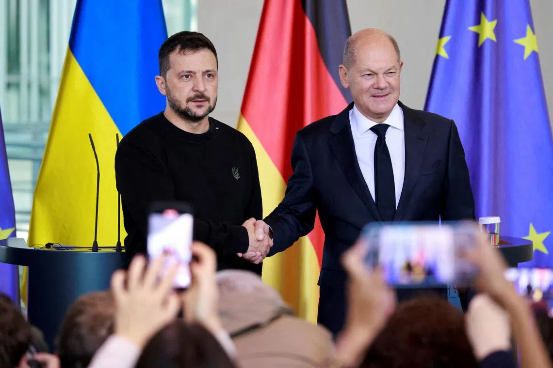 FILE PHOTO: German Chancellor Olaf Scholz and Ukrainian President Volodymyr Zelenskiy shake hands before talks in Berlin, Germany, October 11, 2024. REUTERS/Axel Schmidt/File Photo