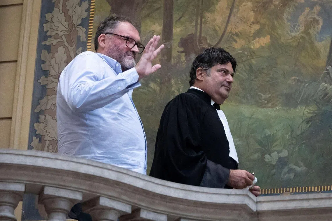 French former anaesthetist Frederic Pechier (L) reacts next to his lawyer Randall Schwerdorffer (R) during a break on the opening day of his trial, at Besancon's courthouse, in Besancon, north eastern France, on September 8, 2025. Frederic Pechier, 53, goes on trial on September 8, 2025, accused of intentionally poisoning 30 patients, 12 of whom died, in an alleged attempt to show off his resuscitation skills and discredit co-workers. (Photo by ROMEO BOETZLE / AFP)
