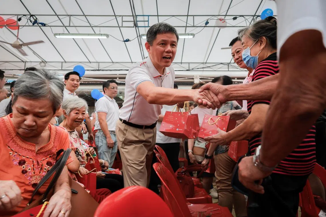 Education Minister Chan Chun Sing distributing oranges to residents at the launch of the new Tanjong Pagar Town 5-year Plan and NRP Completion Ceremony held at Redhill Market and Food Centre on Feb 2, 2025.
