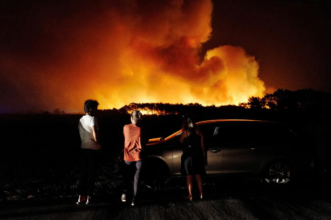 A wildfire in Aljezur, Portugal, on Aug 7. Activists are increasingly turning to courts to force greater efforts by governments to tackle climate change.