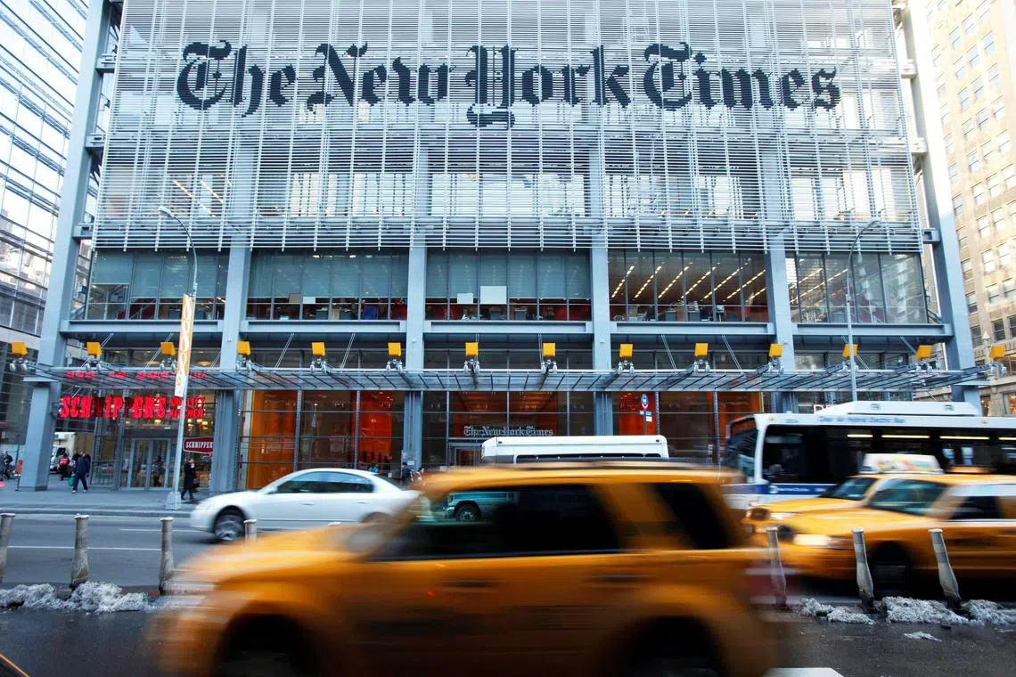 FILE PHOTO: Vehicles drive past the New York Times headquarters in New York March 1, 2010. REUTERS/Lucas Jackson///File Photo
