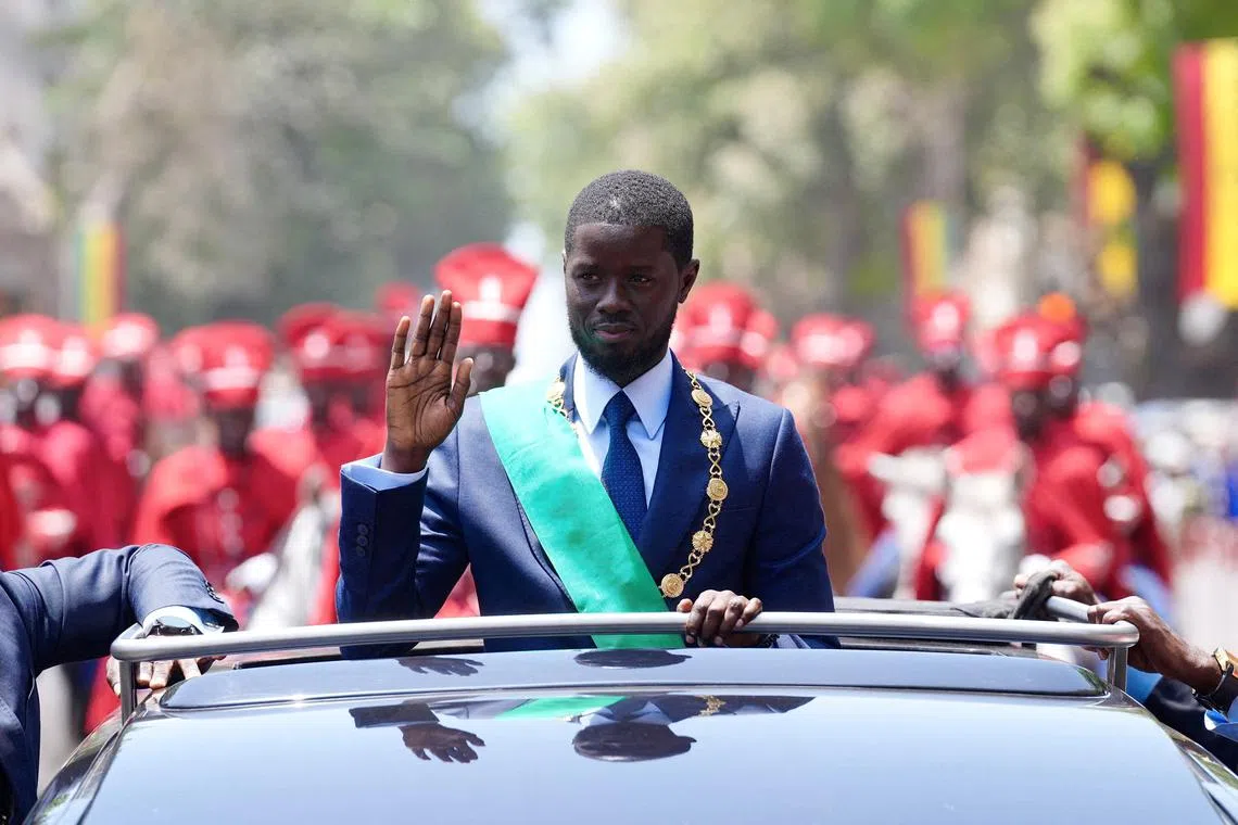 Senegal's newly-elected President Bassirou Diomaye Faye waves to supporters from a car after taking an oath of office as president during the inauguration ceremony in Dakar, Senegal April 2, 2024. REUTERS/Abdou Karim Ndoye/File Photo
