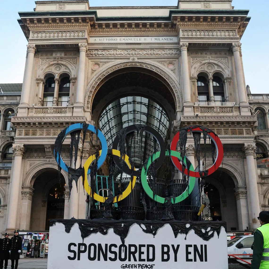 Civic workers remove a symbolic installation by environmental activists from Greenpeace, on the day they stage a protest near the Duomo di Milano, as the Olympic torch arrives in Milan, Italy, February 5, 2026. REUTERS/Claudia Greco