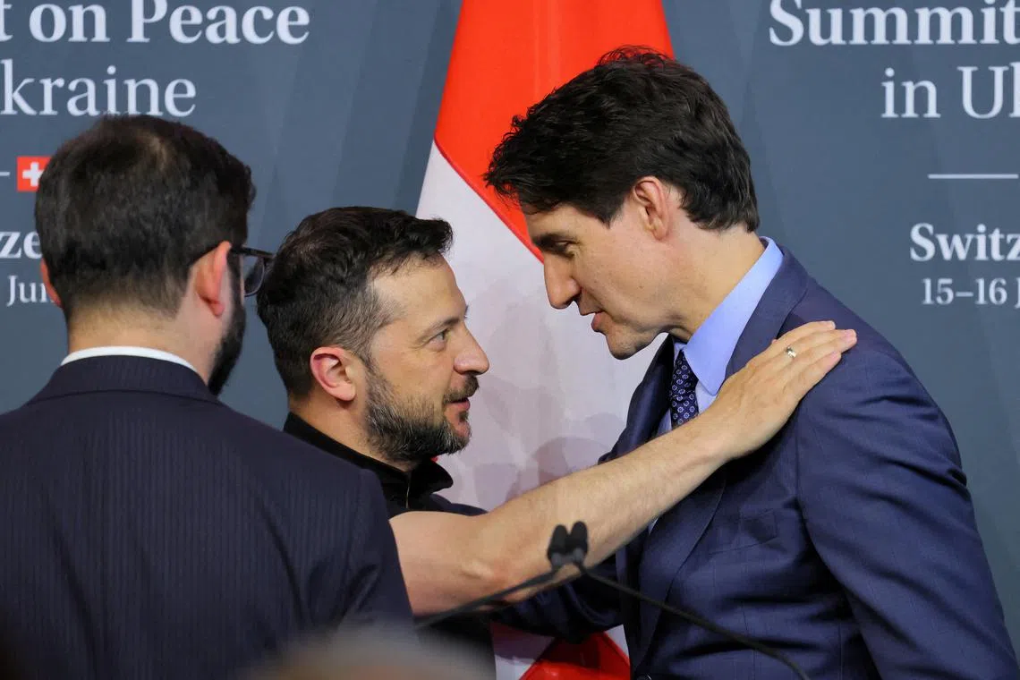 FILE PHOTO: Ukraine's President Volodymyr Zelenskiy and Canada's Prime Minister Justin Trudeau talk during the closing press conference of the Summit on Peace in Ukraine, in Stansstad near Lucerne, Switzerland, June 16, 2024. REUTERS/Denis Balibouse/File Photo
