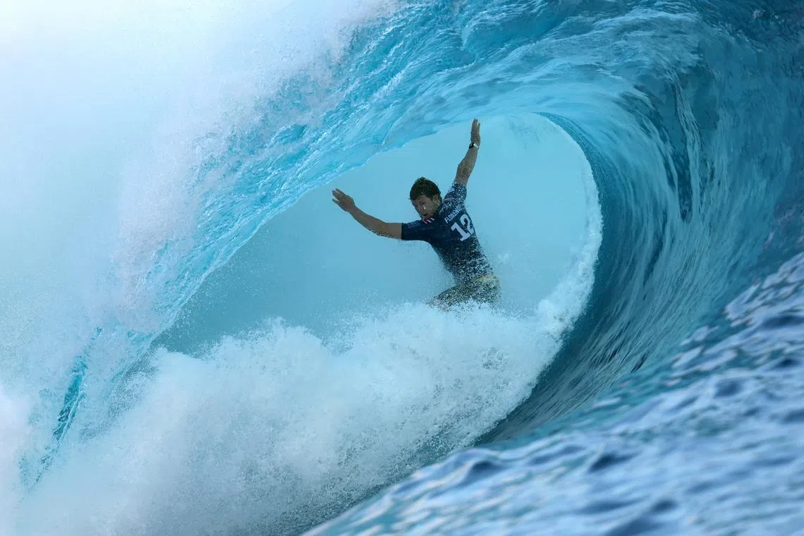 FILE PHOTO: Surfing - World Surf League - Tahiti Pro - Teahupo'o, Tahiti, French Polynesia - May 30, 2024  Hawaii's John John Florence in action during the final REUTERS/Thomas Bevilacqua/File Photo