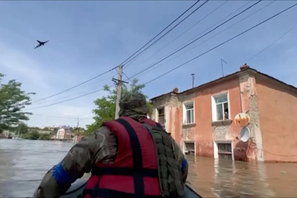 A member of the Ukrainian National Guard takes part in an operation to rescue civilians amid flooding in Kherson, Ukraine.