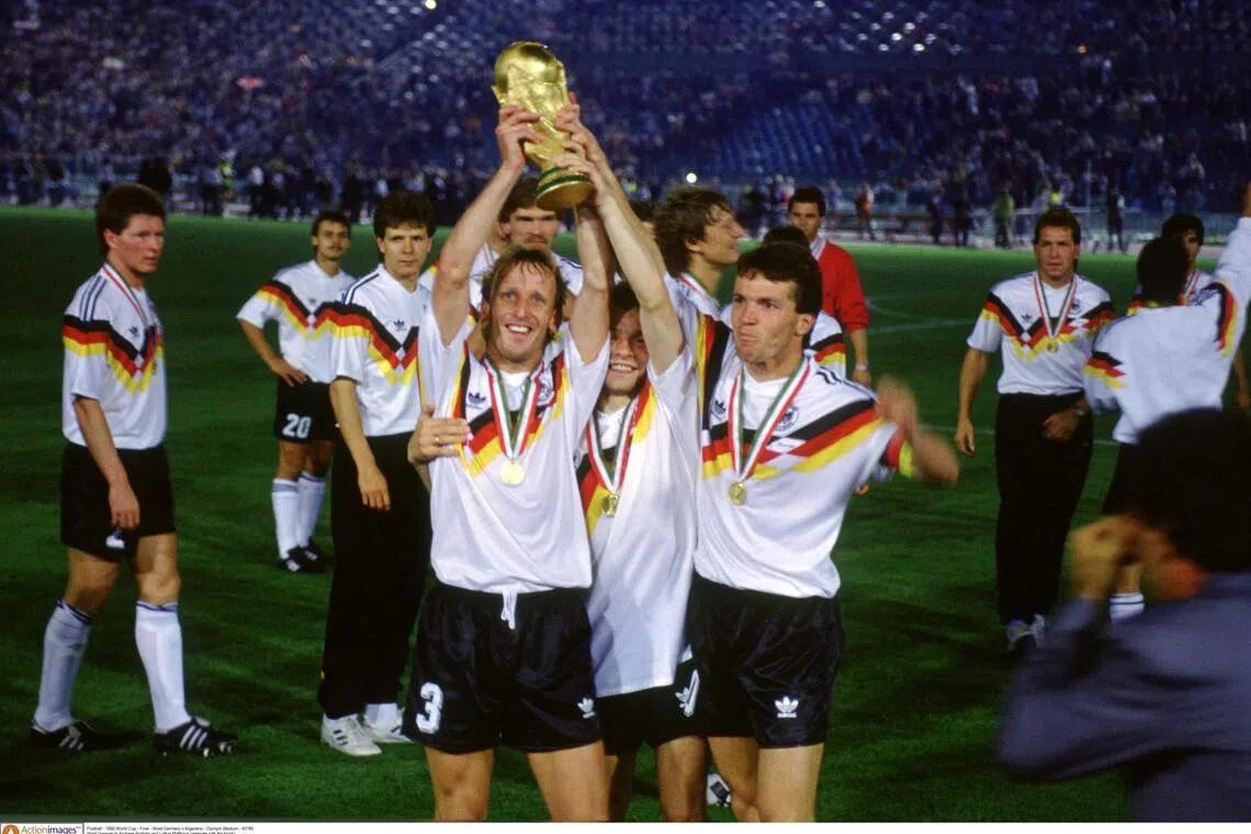 Football - 1990 World Cup - Final - West Germany v Argentina - Olympic Stadium - 8/7/90
West Germany's Andreas Brehme and Lothar Matthaus celebrate with the trophy
Mandatory Credit: Action Images / Sporting Pictures