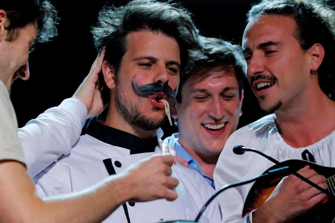 Researchers eat pasta as they accept the physics prize during the 35th Ig Nobel Prize ceremony on Sept 18, 2025.
