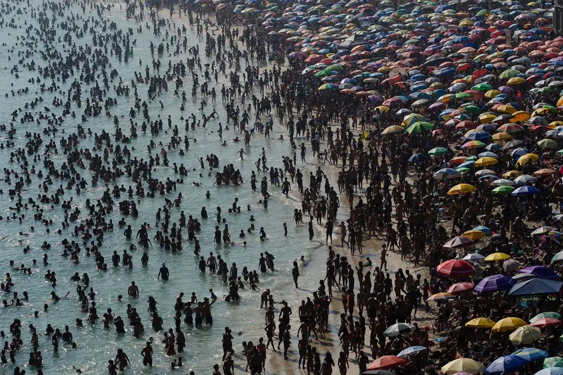 Sunbathers enjoy Macumba beach, in the west zone of Rio de Janeiro, on Sept 24, during a heat wave which registered 39.9 deg Celcius.