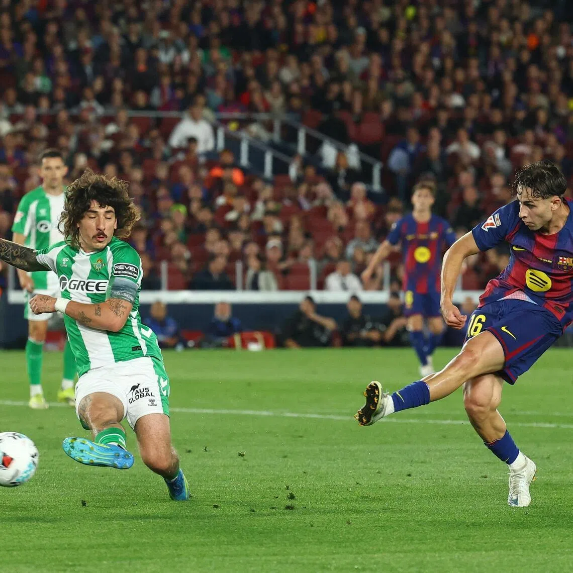 FC Barcelona's Fermin Lopez shooting past Real Betis' Hector Bellerin in their La Liga match at the Camp Nou on May 17, 2026. He suffered a metatarsal fracture in his right foot during the 3-1 win.