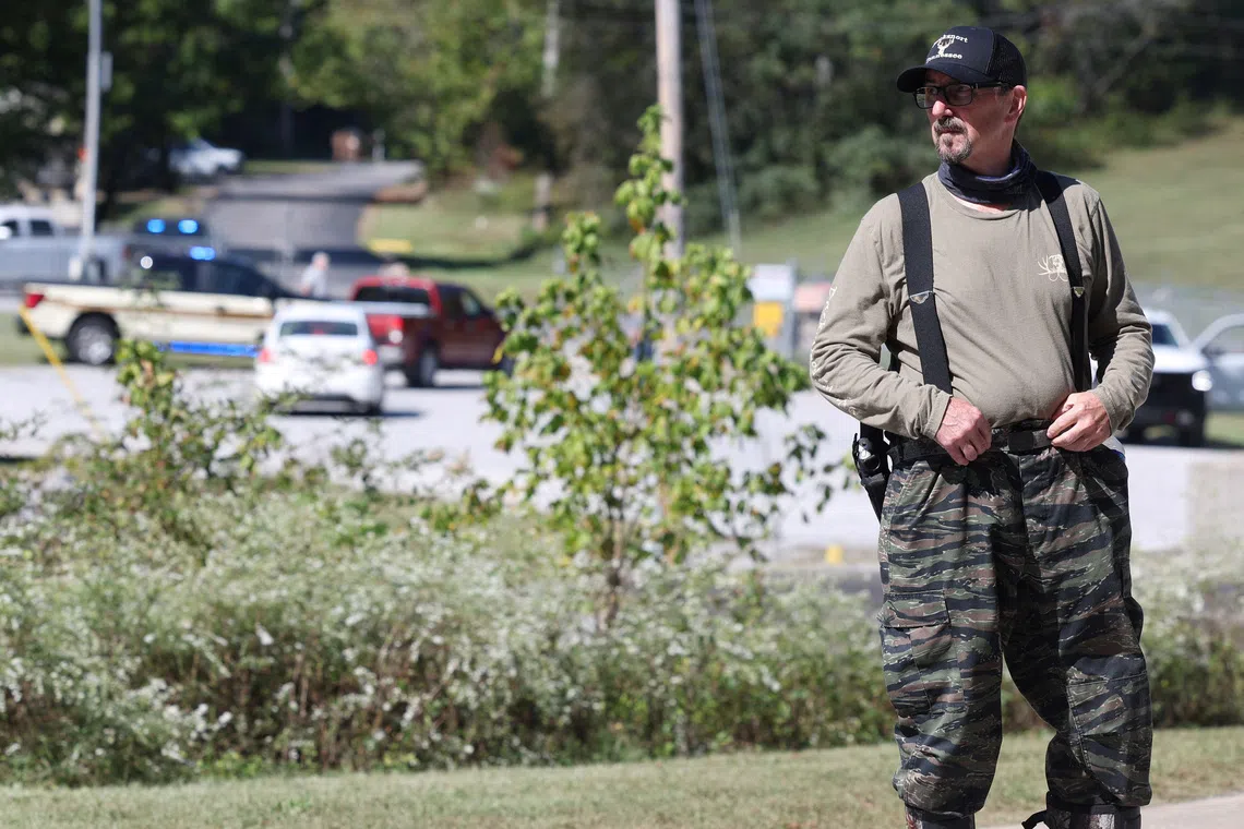 A law enforcement officer guards a gate outside the Accurate Energetic Systems military explosives plant, after an explosion at the facility in Bucksnort, Tennessee, on Oct 10.