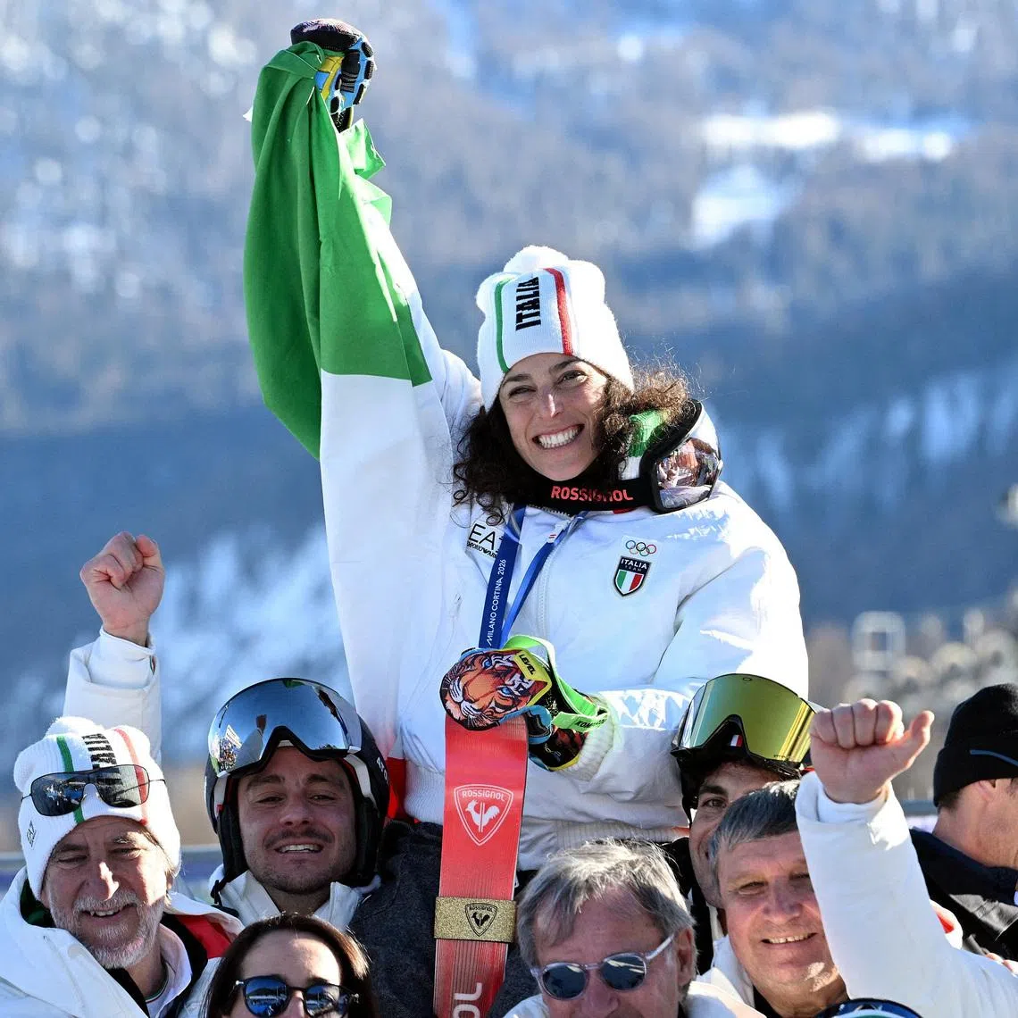 FILE PHOTO: Milano Cortina 2026 Olympics - Alpine Skiing - Women's Giant Slalom Victory Ceremony - Tofane Alpine Skiing Centre, Belluno, Italy - February 15, 2026. Gold medallist Federica Brignone of Italy celebrates with her team during the women's giant slalom victory ceremony REUTERS/Jennifer Lorenzini/File Photo