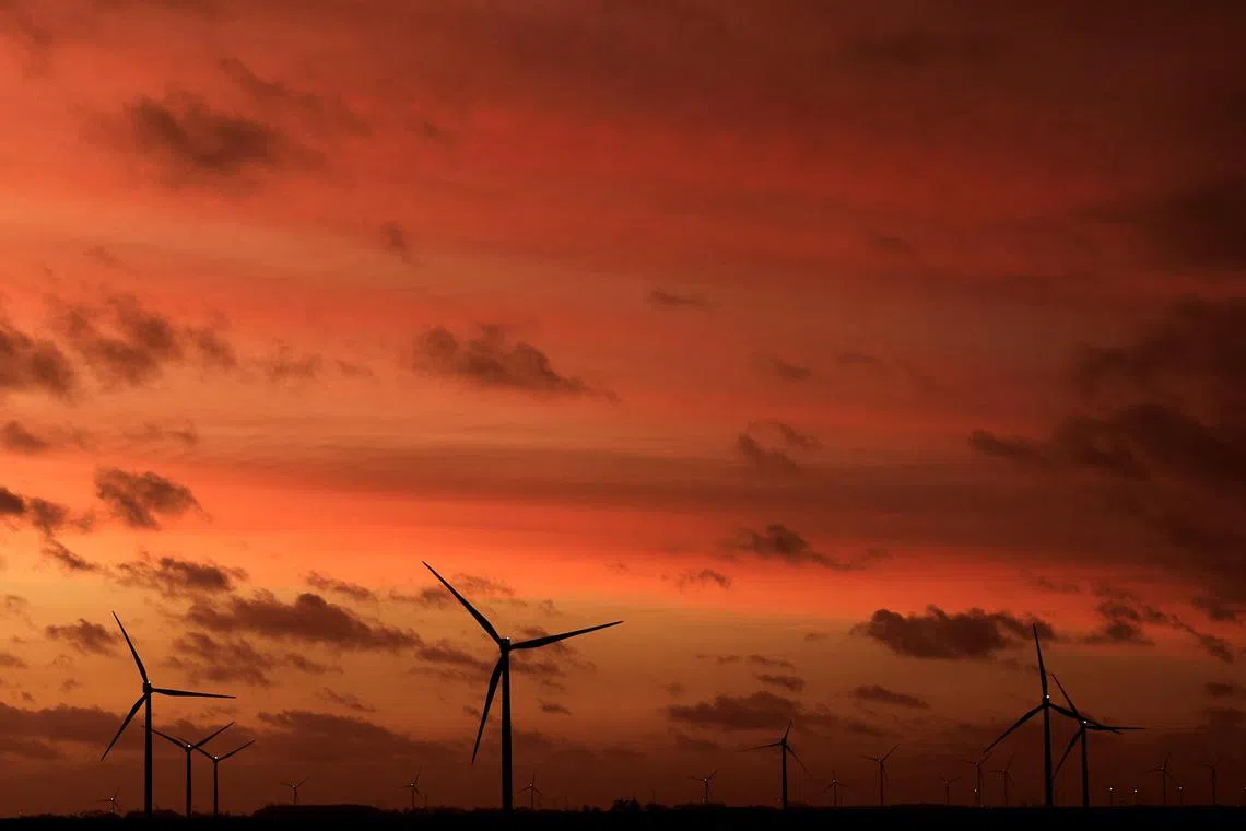 Power-generating windmill turbines stand at sunset during the winter solstice at a wind park in Beugny, France, December 22, 2023. REUTERS/Pascal Rossignol