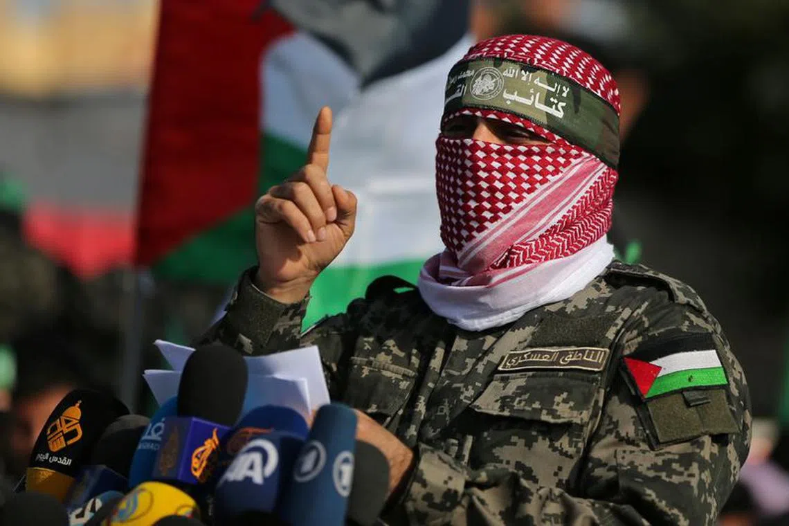 Abu Ubaida, the spokesman of the Izz el-Deen al-Qassam Brigades, gestures as he speaks during an anti-Israel military show in the southern Gaza Strip November 11, 2019. REUTERS/Ibraheem Abu Mustafa/File Photo