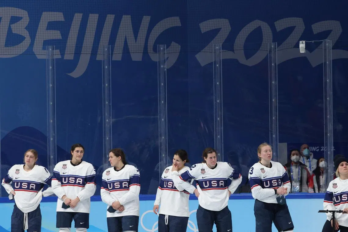 2022 Beijing Olympics - Victory Ceremony - Ice Hockey - Women's Gold Medal - Wukesong Sports Centre, Beijing, China - February 17, 2022. Kelly Pannek of the United States, Brianna Decker of the United States and teammates look dejected during the medal ceremony. REUTERS/Brian Snyder