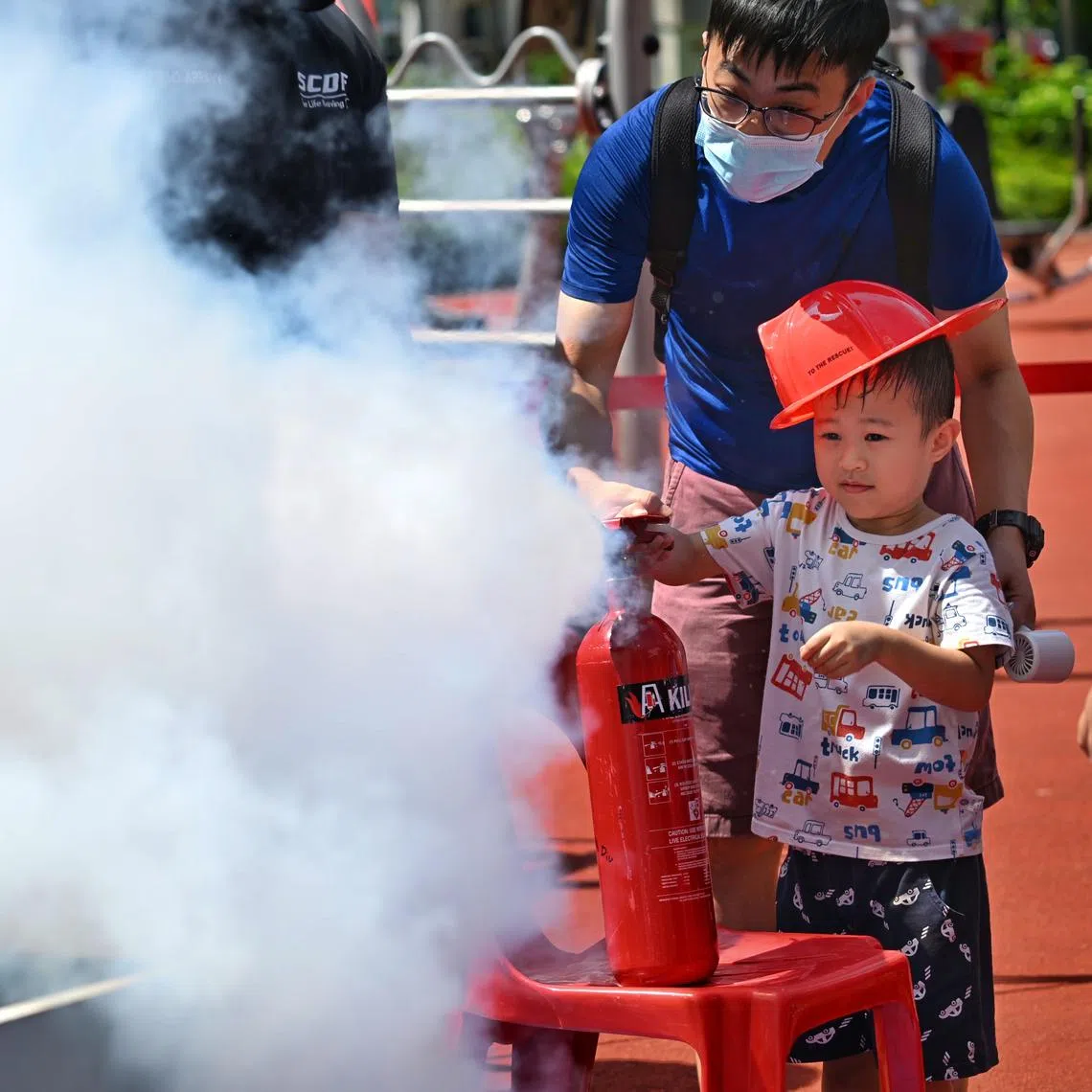 Residents trying to put out a fire at Chua Chu Kang GRC and Bukit Gombak SMC’s Community Resilience Day event on May 25.