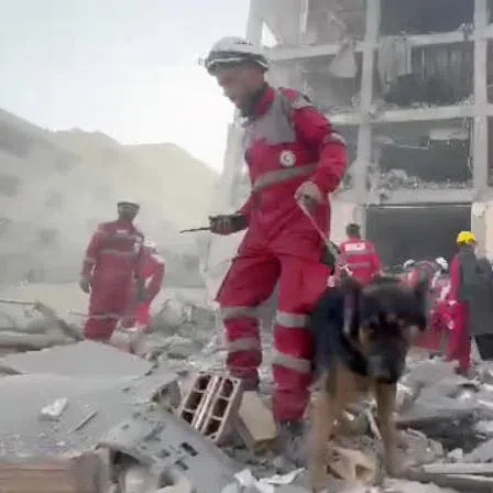 Rescuers work in the rubble of residential buildings after air strikes, in the Resalat neighbourhood, in Tehran, Iran.