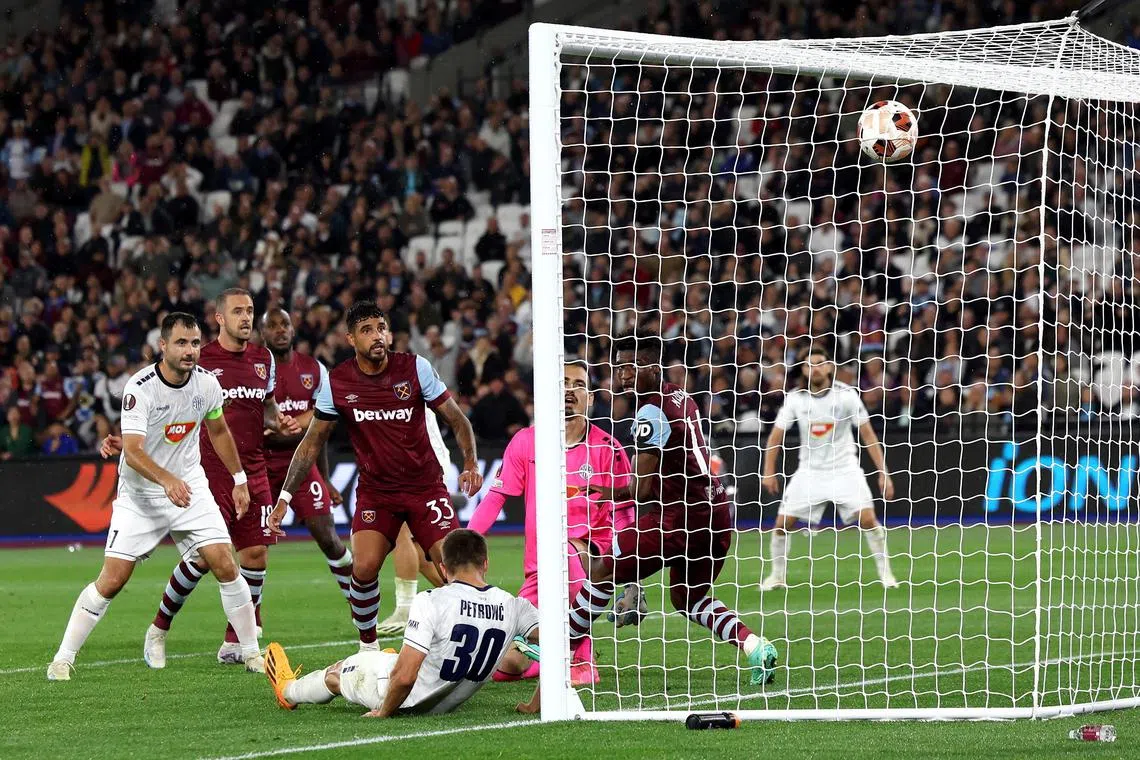 Nemanja Petrovic of Topola scores an own goal against West Ham United.