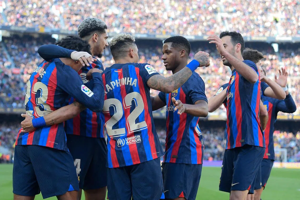 Barcelona' players celebrate a La Liga goal against Valencia at their Camp Nou stadium, on March 5, 2023..