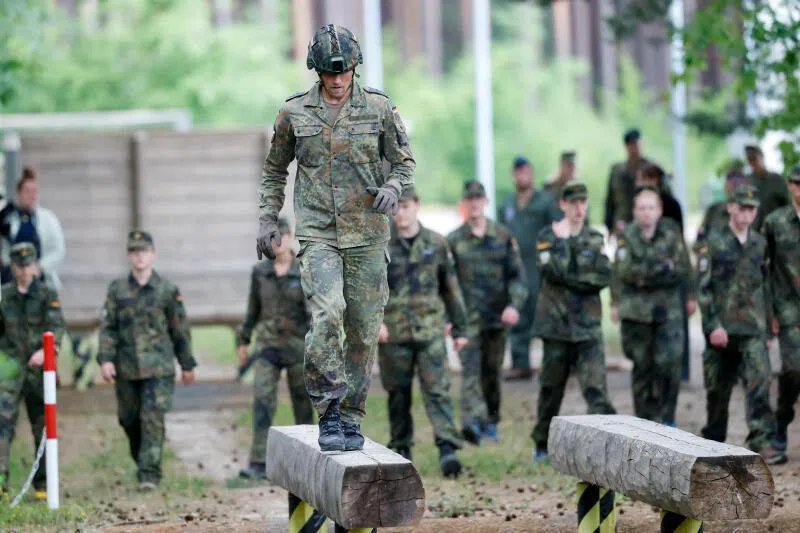Potential Bundeswehr recruits observing a regular going through an obstacle course at a German military base in July.