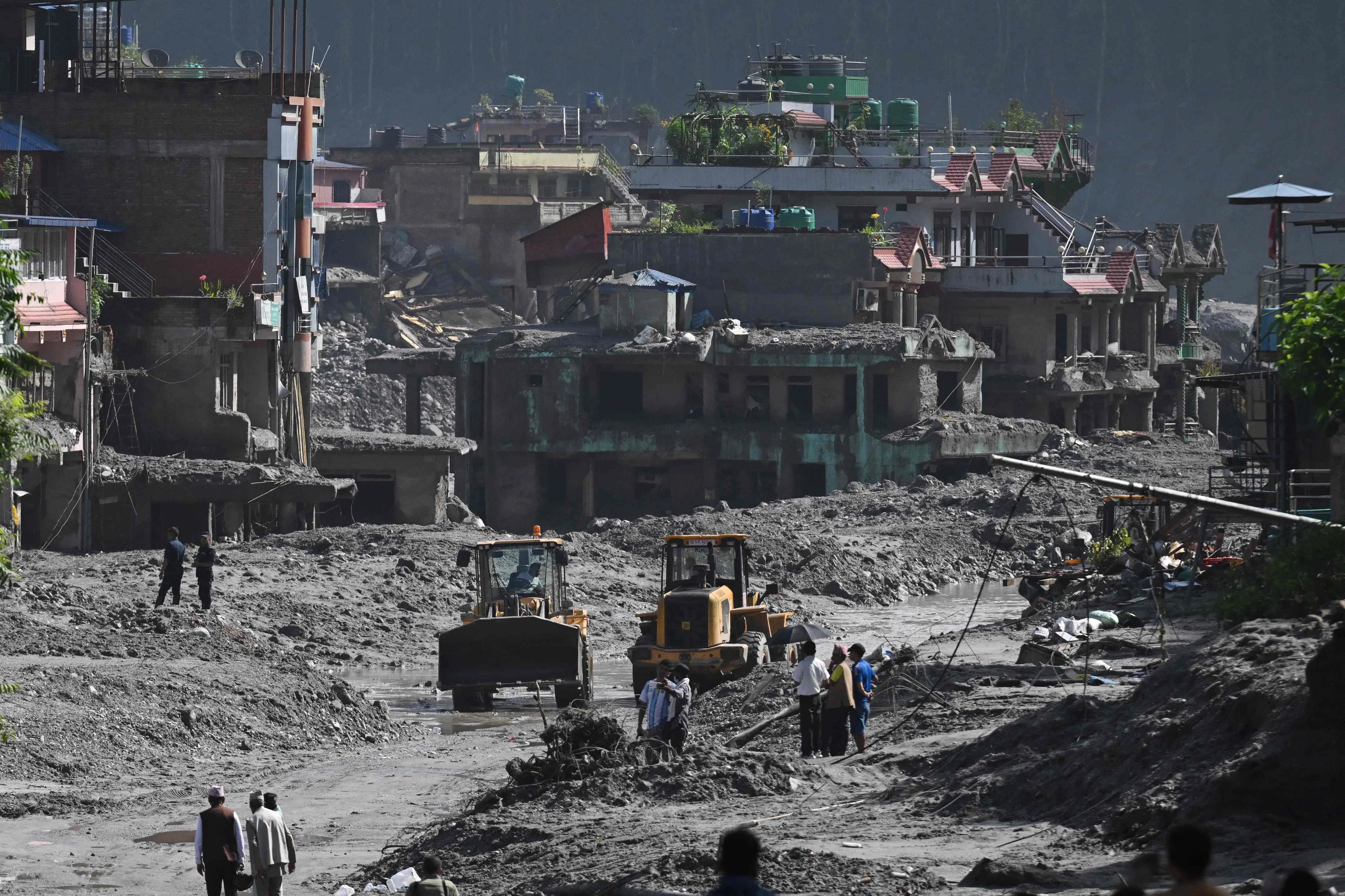 TOPSHOT - Rescue works continue at Trishuli Center in Nepal's Nuwakot district on August 30, 2026, after catastrophic flooding on the Nepal-Tibet border. The number of people missing in the catastrophic flood that sliced through the border area between Nepal and Tibet neared 3,000 on August 30, as rescuers scoured deep, leg-sucking mud for survivors. (Photo by Arun SANKAR / AFP)