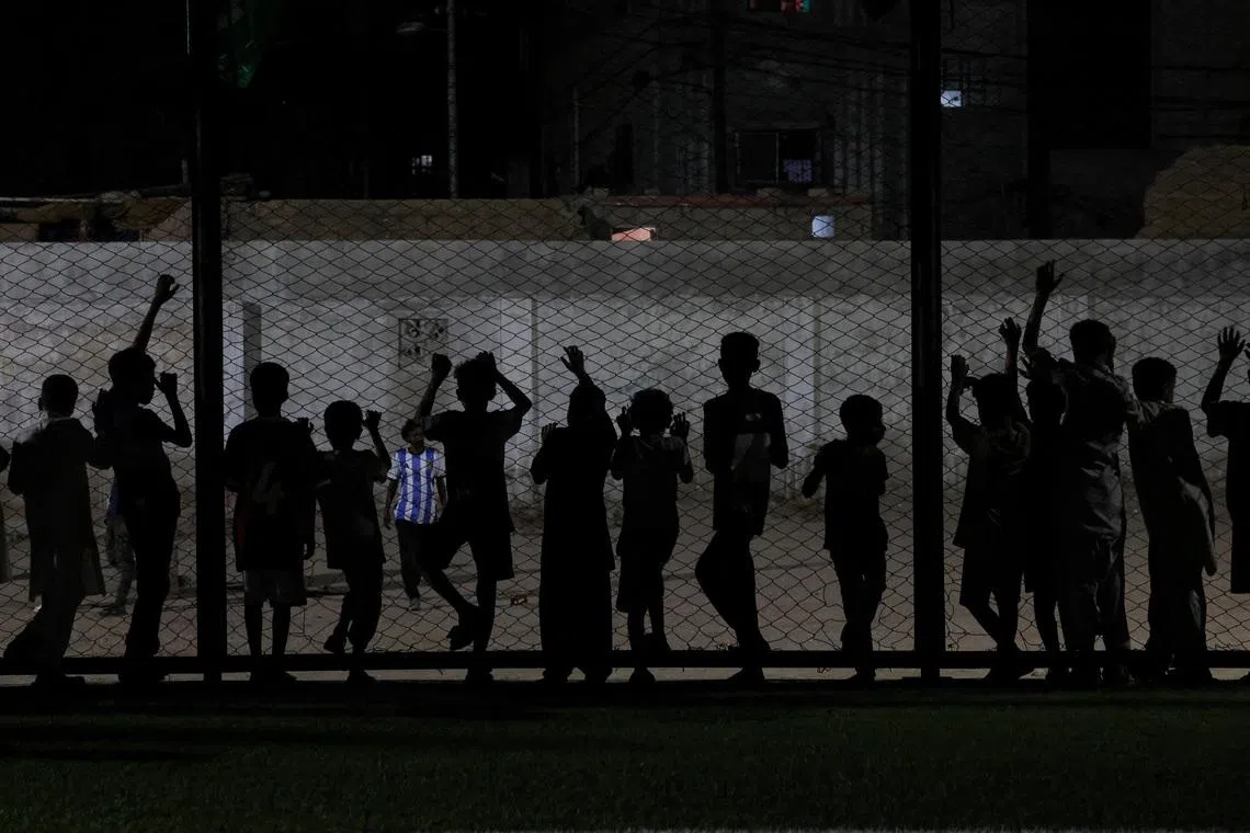 Pakistani soccer fans standing by a fence, as they gather to watch the FIFA World Cup 2026 Group A match between Mexico and South Africa, in Karachi, Pakistan, on June 11, 2026. 