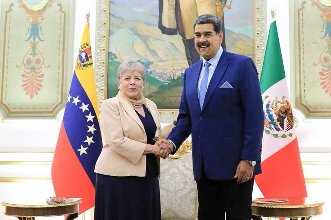 Mexican Foreign Minister Alicia Barcena shakes hands with Venezuelan President Nicolas Maduro, ahead of the October 22 migration summit of leaders from Latin America and the Caribbean, which will be held in Palenque, Mexico, at the Miraflores Palace in Caracas, Venezuela, October 16, 2023. Mexico Foreign Relations Ministry (SRE)/Handout via REUTERS